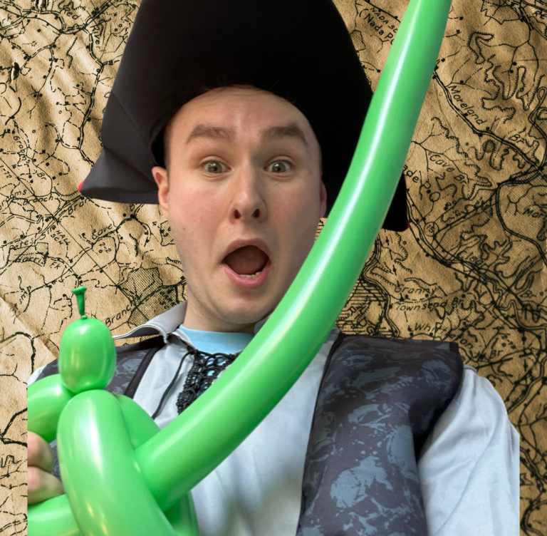 Young woman with a purple headband and orange jacket against a blue background.